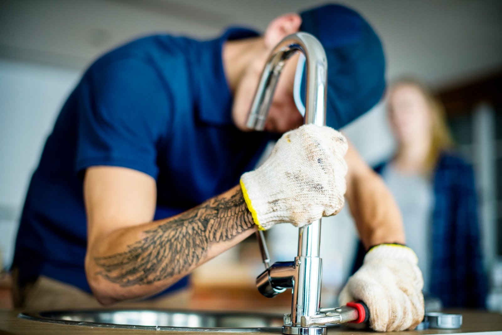 Plumber fixing kitchen sink